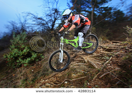 stock-photo-a-young-man-riding-a-mountain-bike-downhill-style-42883114